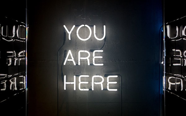 Neon sign saying You Are Here